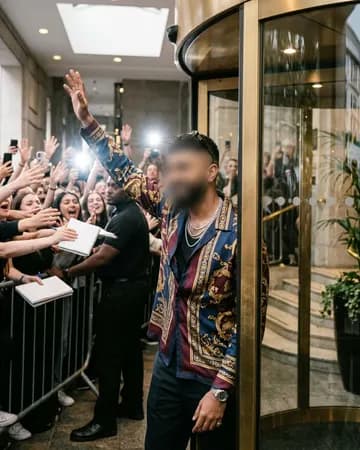 Stepping out of a hotel like a pop star to a mob of screaming fans