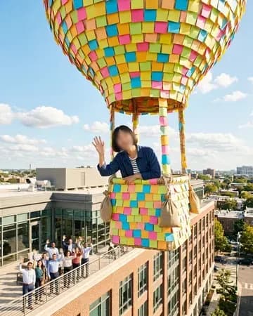 Waving goodbye from a hot-air balloon made of sticky notes